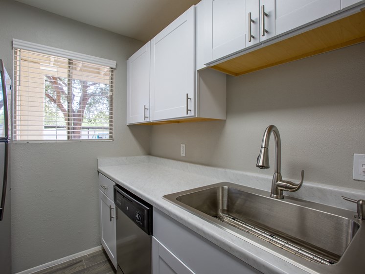Renovated apartment kitchen in Tucson with modern fixtures at The Vintage on Speedway Blvd.